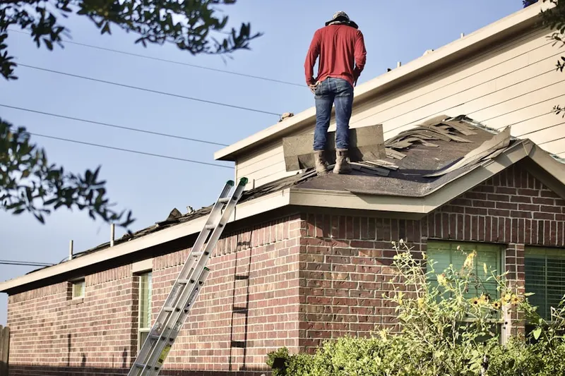 Professional roofer working on a residential roof in Austin Square